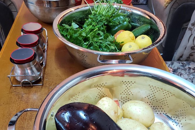 Suhaila (connecting through cooking) - The meal on the floor is part of the lesson